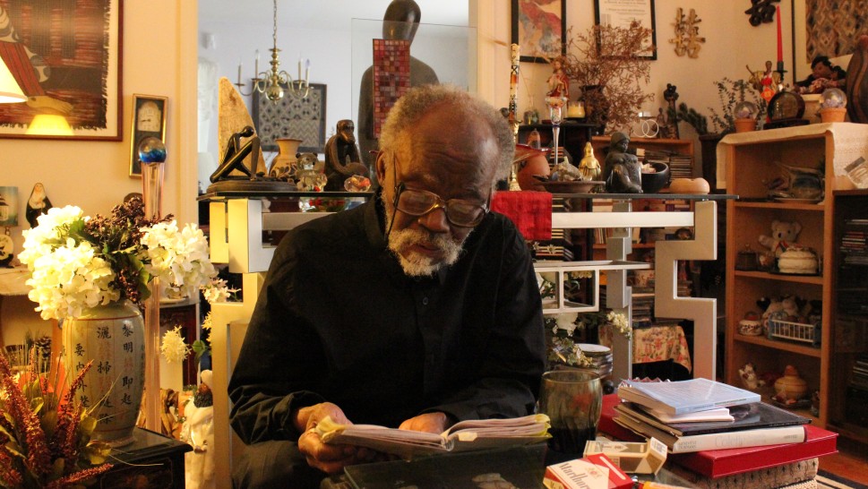  Valentin Yves Mudimbe reads amid his many books and objectsalr