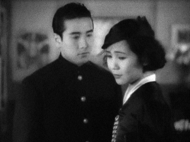 a young Japanese man looks at a young Japanese woman who turns her head awayalr