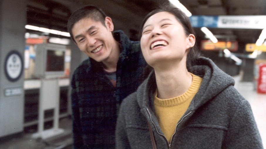 man and woman laughing in the subway stationalr
