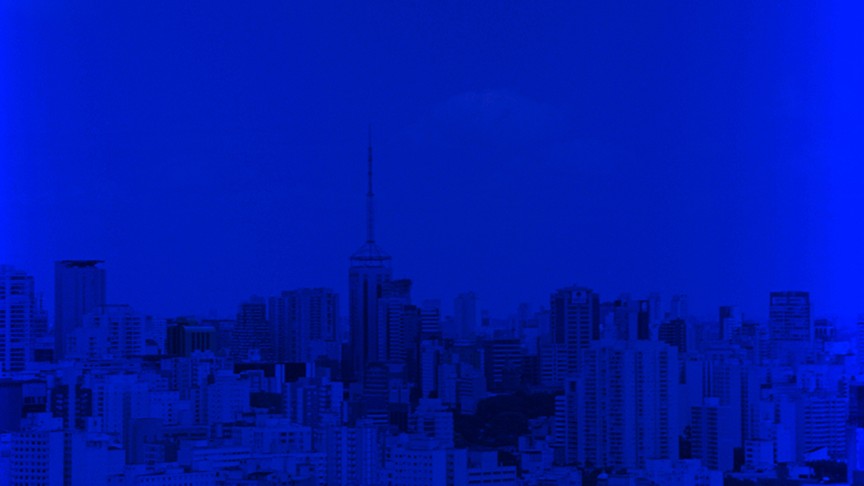 a cityscape saturated in a deep bluealr