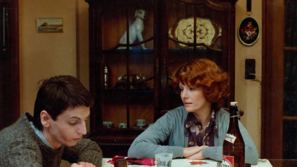 Delphine Seyrig as Jeanne Dielman at the dinner table with her teenage sonalr