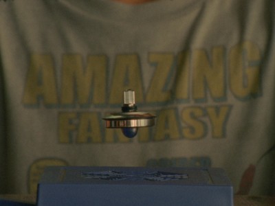 floating, spinning top in front a a boy's t-shirt that says "Amazing Fantasy"