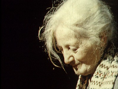 a close-up side portrait of an older white woman with white hair
