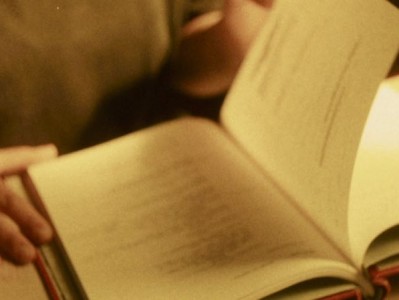 a close-up of hands leafing through a book