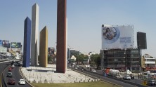 Tall, modernist towers of Luis Barragán's Torres de Satélite in Mexico City with billboard nearby