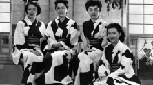 a group of women wearing the same graphically printed traditional Japanese dress